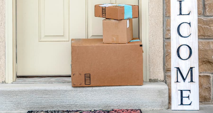 Packages on the doorstep of a home with a welcome sign in Dallas